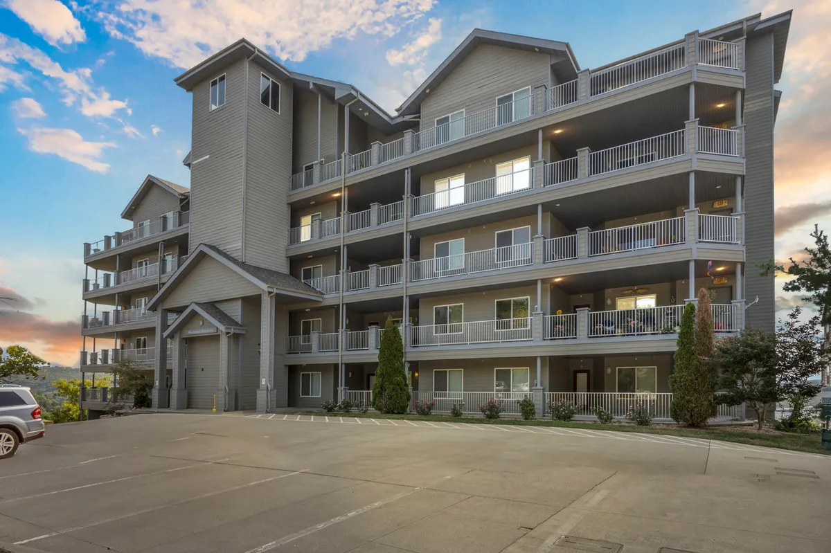 A welcoming view of the building’s exterior, featuring balconies, attractive landscaping, and communal outdoor areas—suggesting both privacy and community.