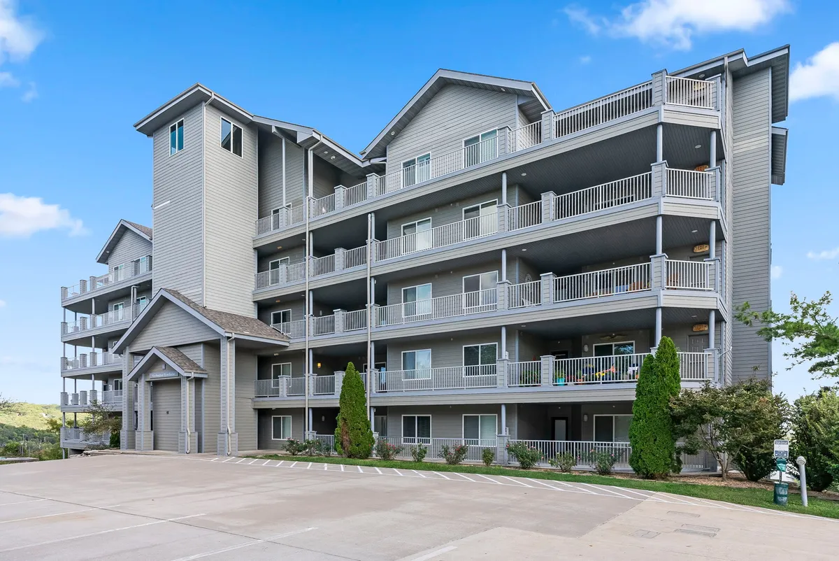 This exterior shot features a multi-level building with balconies and landscaped grounds. The balconies invite relaxation and socializing, while the landscaping hints at shared spaces ideal for group gatherings and downtime after exploring.